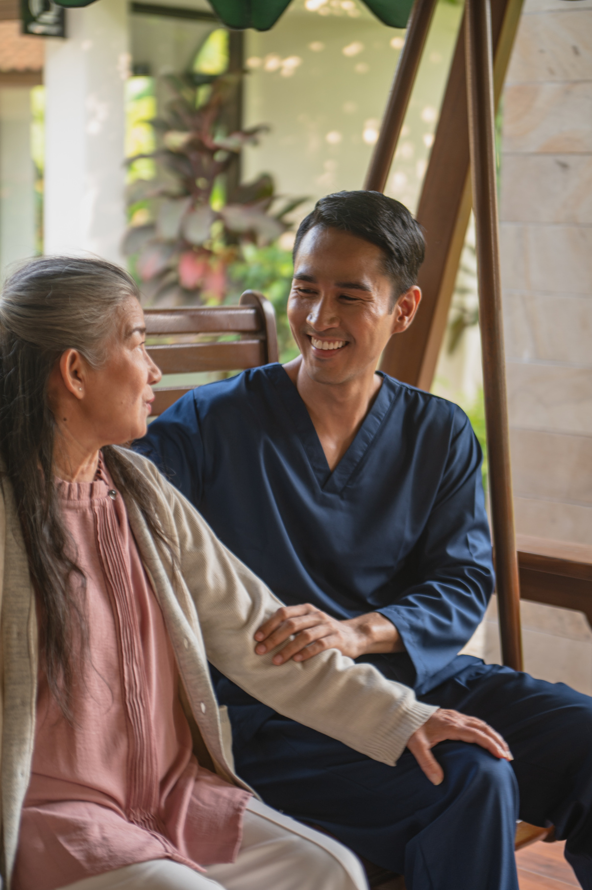 Man Taking Care of an Elderly Woman